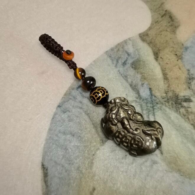 Crafted from golden sheen obsidian and shaped as Pi Xiu—Protection· Wealth· Luck